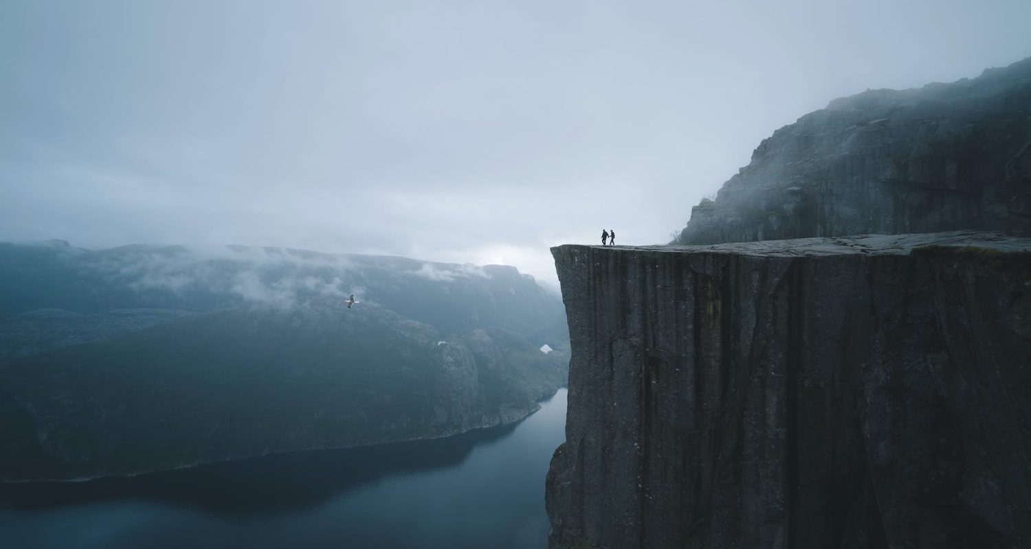 two people on mountain cliff